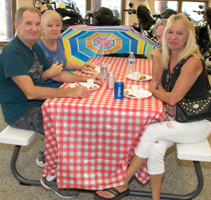 Family sitting at picnic table at superstition harley indoor picnic